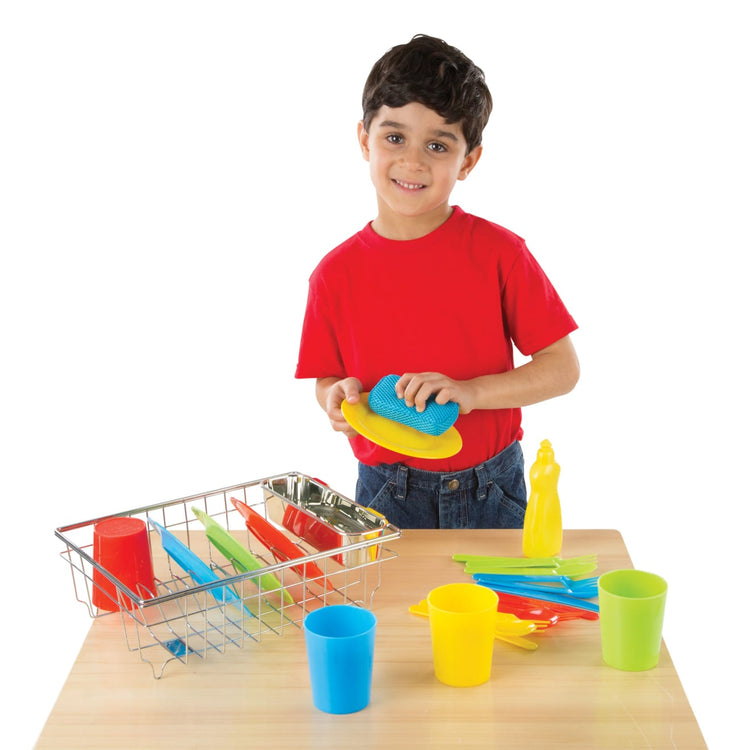 A child on white background with the Melissa & Doug Wash and Dry Dish Set - 24 Pieces