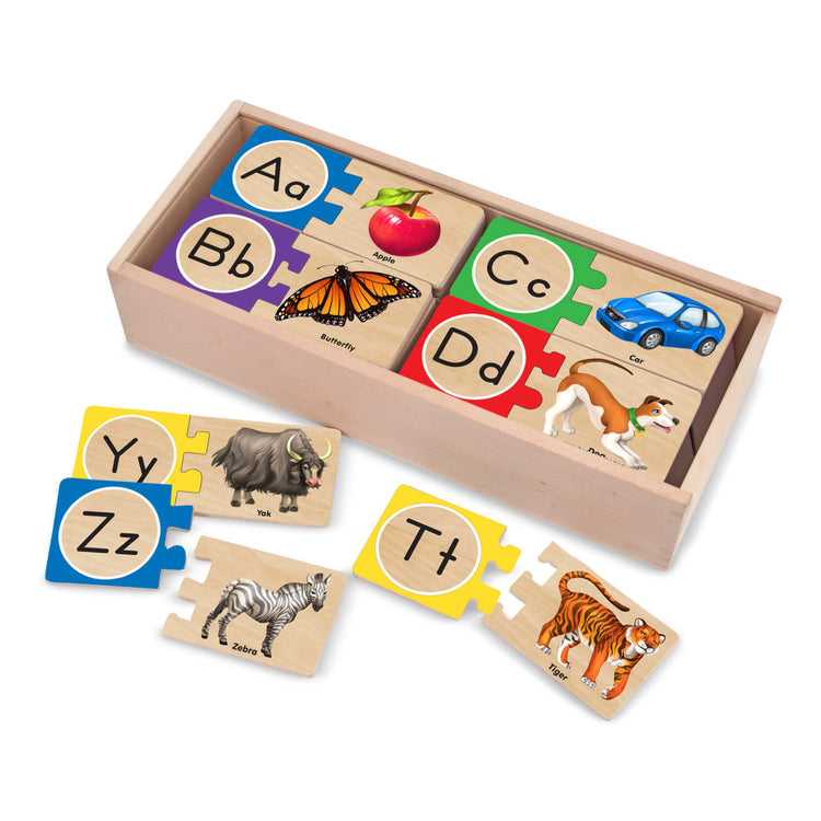 The loose pieces of the Melissa & Doug Wooden Self-Correcting Alphabet Letter Puzzles With Storage Box (52 pcs)