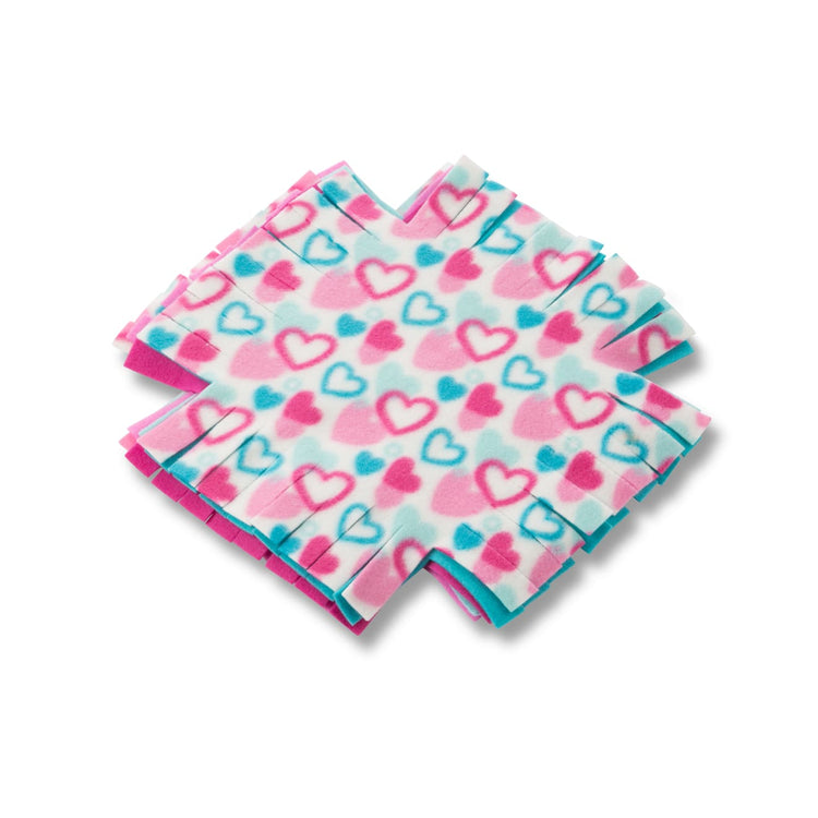 The loose pieces of the Melissa & Doug Created by Me! Heart Fleece Blanket No-Sew Craft Kit (40 squares, 3.5 feet x 5 feet)
