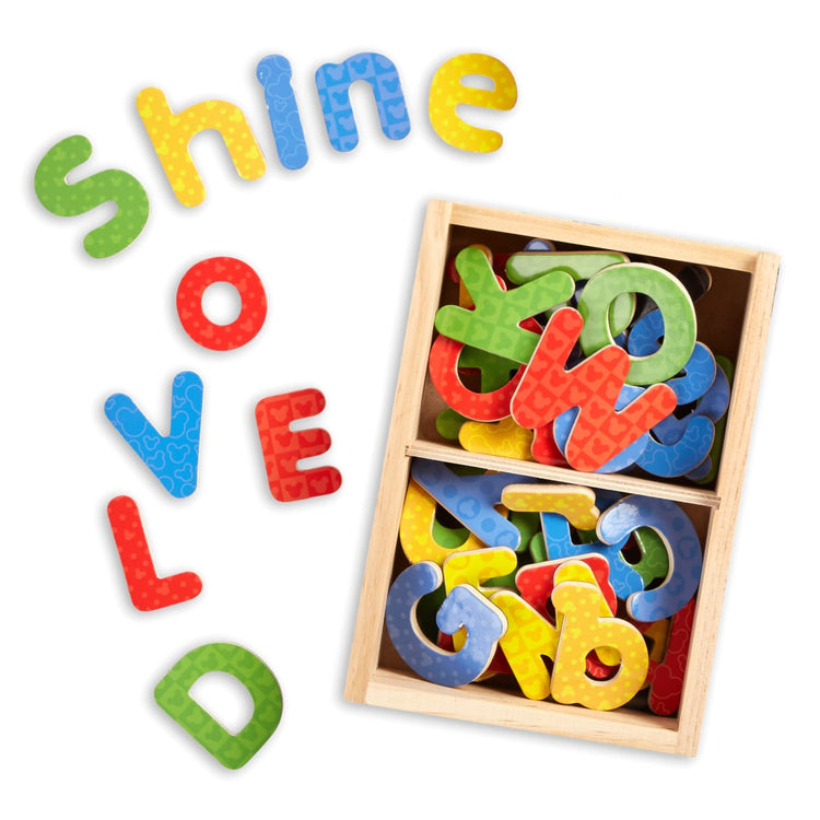 T child on white background with the Melissa & Doug Disney Mickey and Friends Wooden Alphabet Magnets - 52 Uppercase and Lowercase Letters