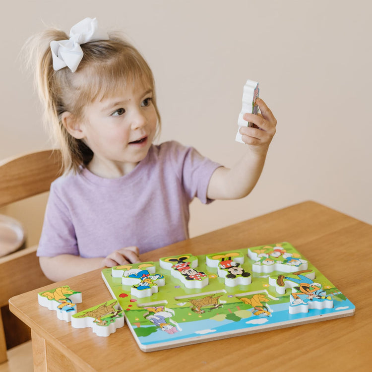 A kid playing with the Melissa & Doug Disney Mickey Mouse Clubhouse Wooden Chunky Puzzle (8 pcs)