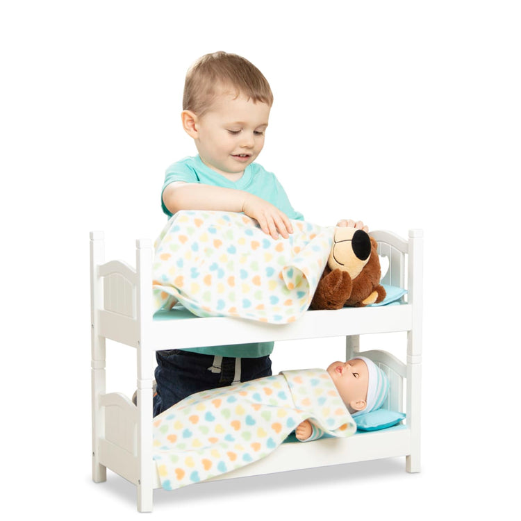 A child on white background with the Melissa & Doug Mine to Love Wooden Play Bunk Bed for Dolls, Stuffed Animals - White (2 Beds, 17.4”H x 9.1”W x 20.7”L Assembled and Stacked)