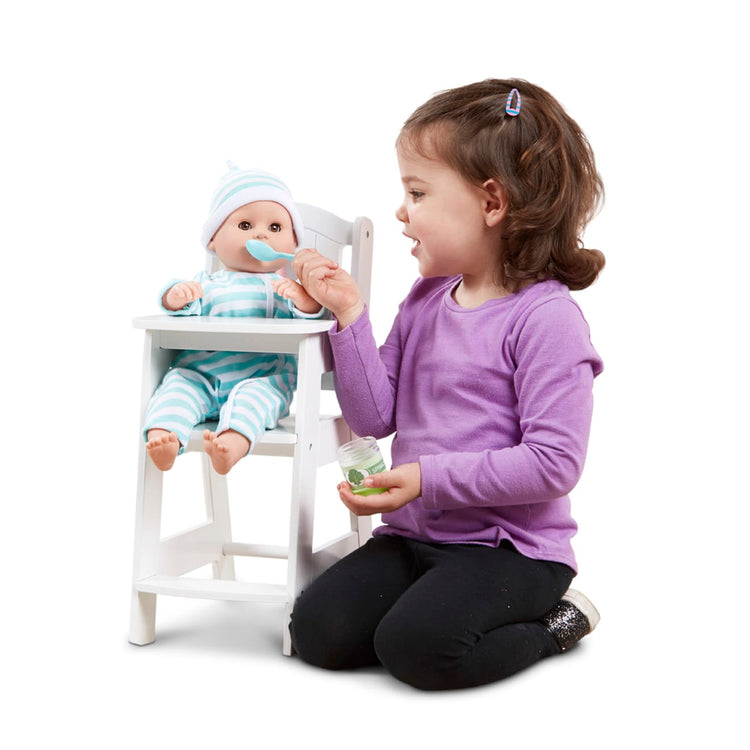 A child on white background with the Melissa & Doug Mine to Love Wooden Play High Chair for Dolls, Stuffed Animals - White (18”H x 8”W x 11”D Assembled)