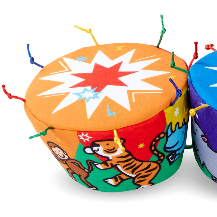 A child on white background with the Melissa & Doug K's Kids Bongo Drums Soft Musical Instrument