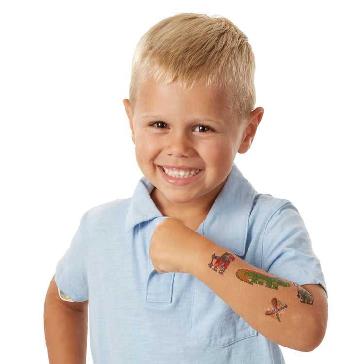 A child on white background with the Melissa & Doug My First Temporary Tattoos: Adventure, Creatures, Sports, and More - 100+ Kid-Friendly Tattoos