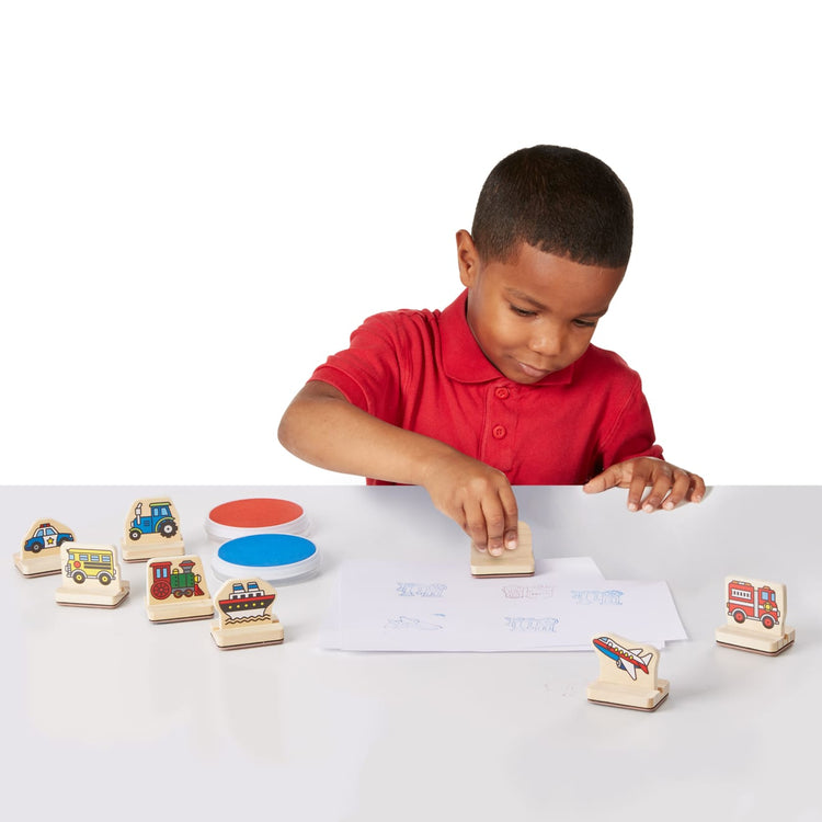 A child on white background with the Melissa & Doug My First Wooden Stamp Set - Vehicles