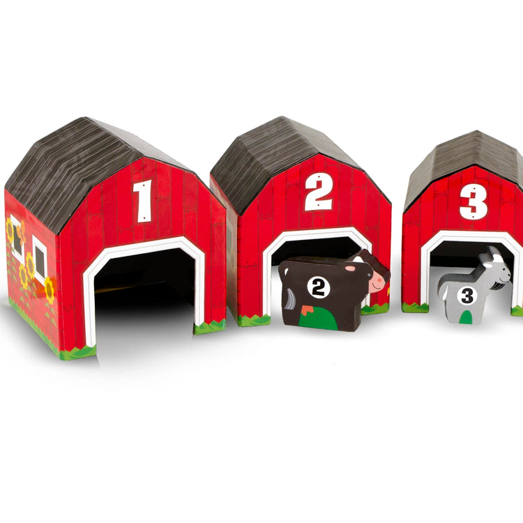 The loose pieces of the Melissa & Doug Nesting and Sorting Barns and Animals With 6 Numbered Barns and Matching Wooden Animals
