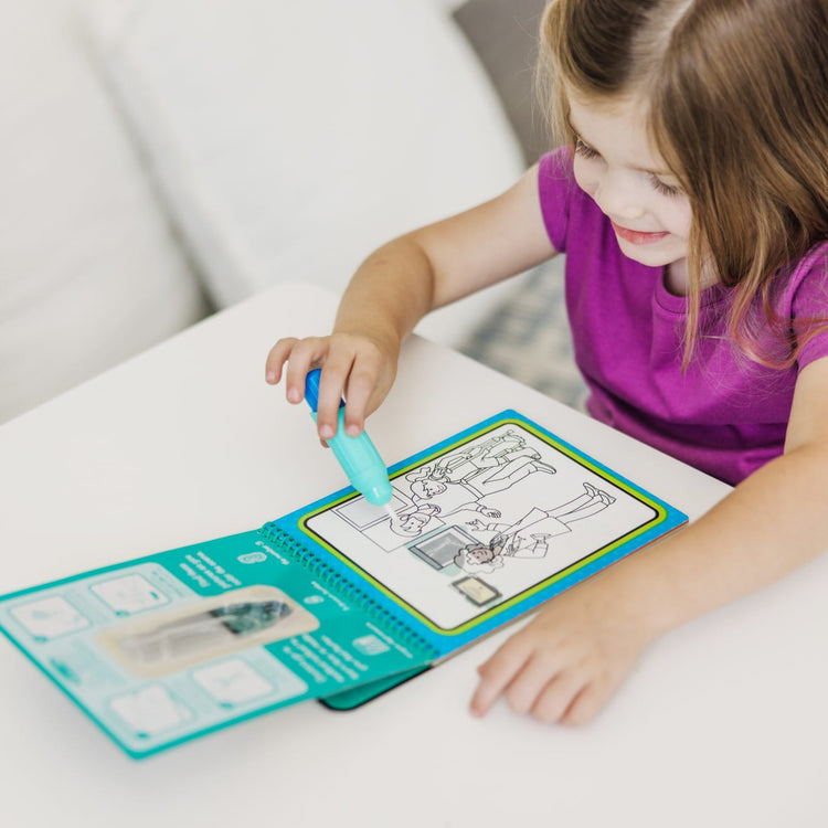 A kid playing with the Melissa & Doug On the Go Water Wow! Reusable Water-Reveal Activity Pad – Occupations