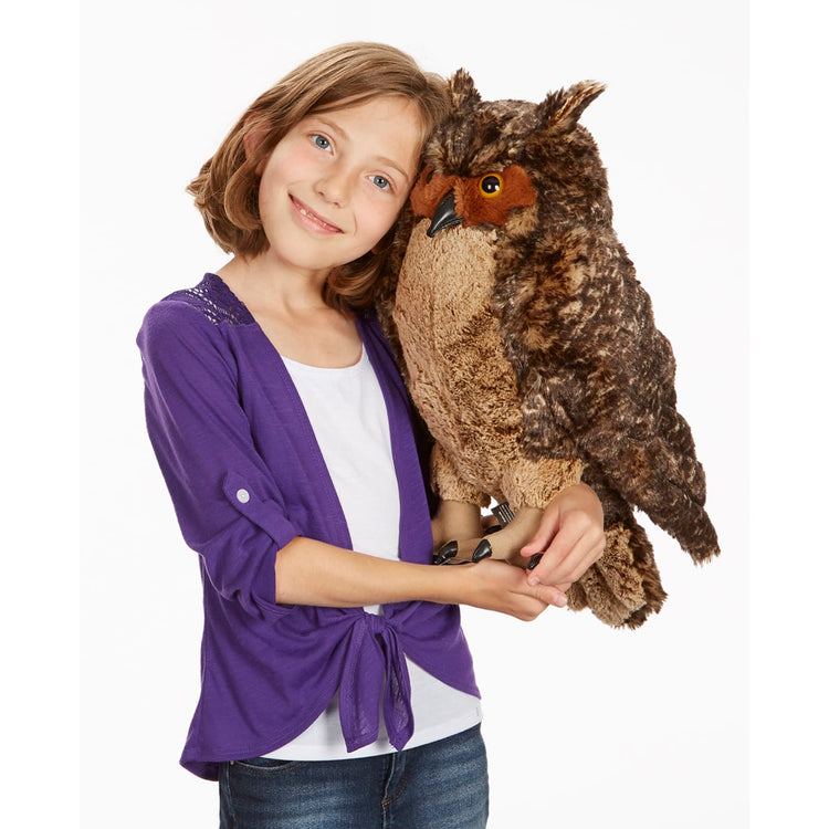 A child on white background with the Melissa & Doug Giant Owl - Lifelike Stuffed Animal (17 inches tall)