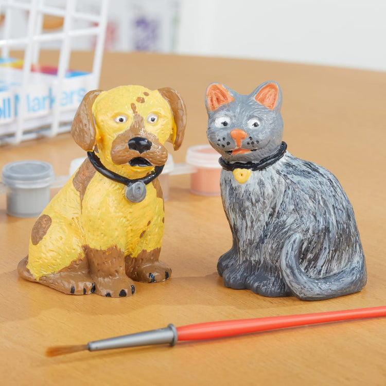 The front of the box for the Melissa & Doug Created by Me! Pet Figurines Craft Kit (Resin Dog and Cat, 6 Paints, Paintbrush)