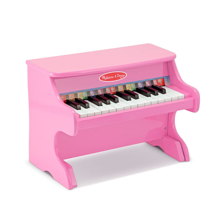 The loose pieces of the Melissa & Doug Learn-to-Play Pink Piano With 25 Keys and Color-Coded Songbook
