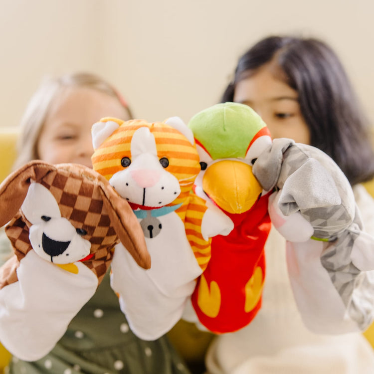 A kid playing with the Melissa & Doug Playful Pets Hand Puppets (Set of 4)