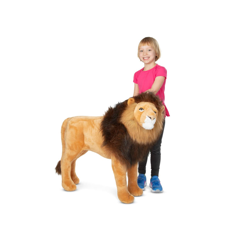A child on white background with the Melissa & Doug Standing Lion Lifelike Stuffed Animal With Full Mane, More Than 2 Feet Tall, Nearly Three Feet Long