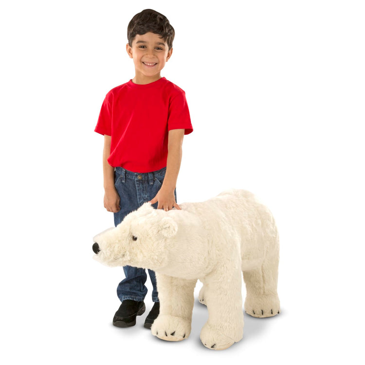 A child on white background with the Melissa & Doug Giant Polar Bear - Lifelike Stuffed Animal (nearly 3 feet long)