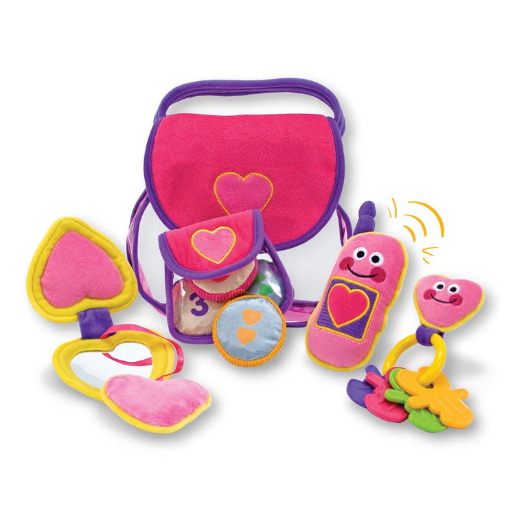 The loose pieces of the Melissa & Doug Pretty Purse Fill and Spill Soft Play Set Toddler Toy