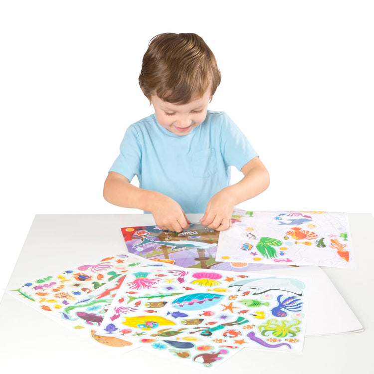 A child on white background with the Reusable Sticker Pad Bundle - Jungle, Farm & Under the Sea (Amazon Only)