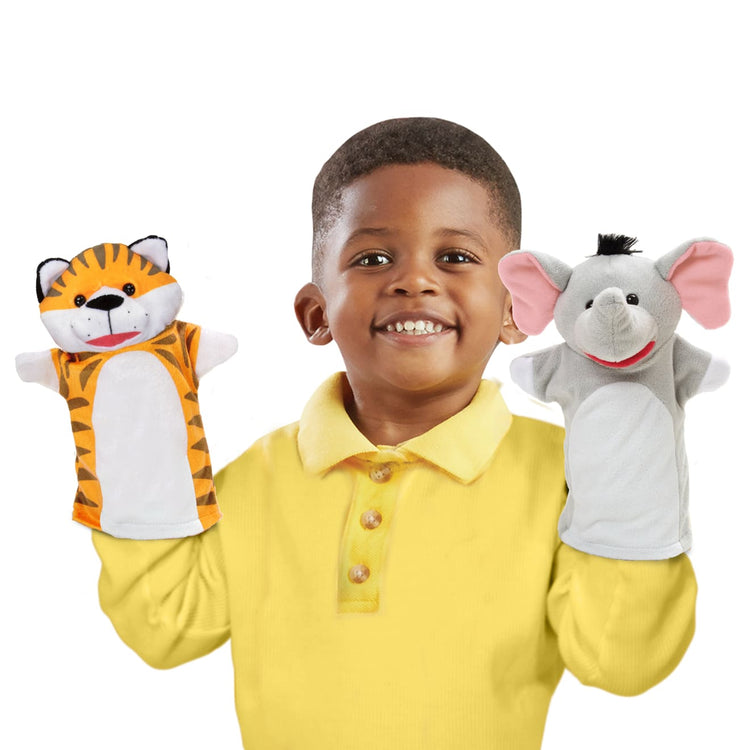 A child on white background with the Melissa & Doug Safari Buddies Hand Puppets, Set of 6 (Elephant, Tiger, Parrot, Giraffe, Monkey, Zebra)