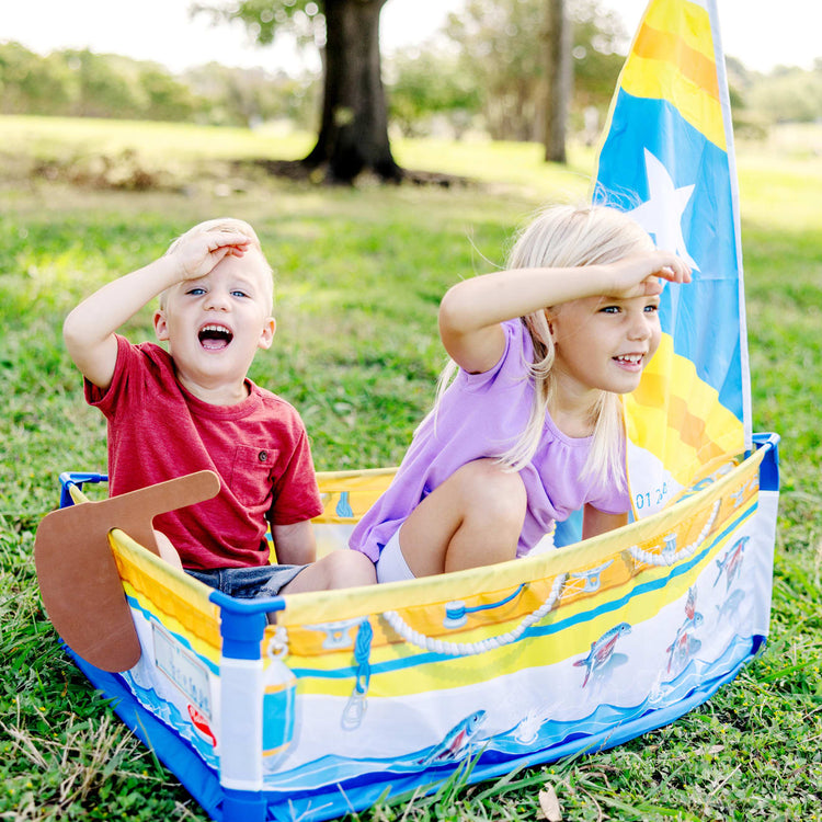 A kid playing with the Melissa & Doug Let’s Explore™ Sailboat Play Set