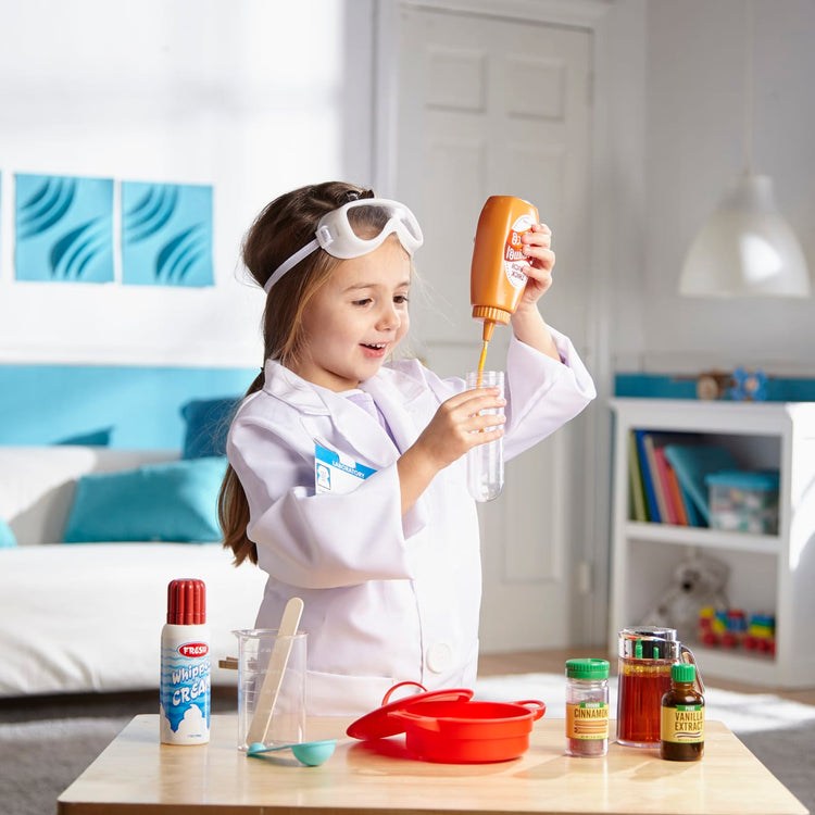 A kid playing with the Melissa & Doug Scientist Role Play Costume Set (X pcs) - Lab Coat, Goggles, 6 Experiments