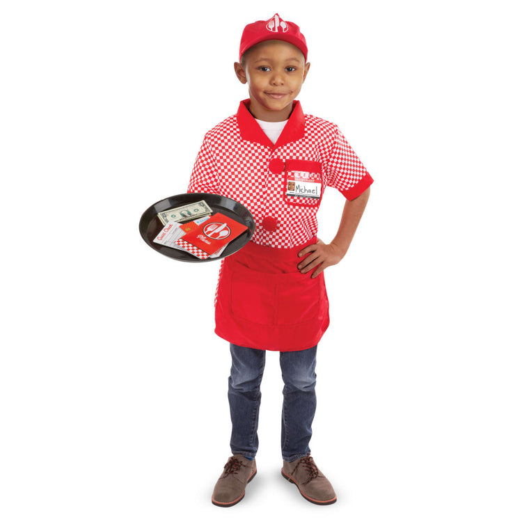 A child on white background with the Melissa & Doug Server Costume Role Play Dress-Up Set With Realistic Accessories