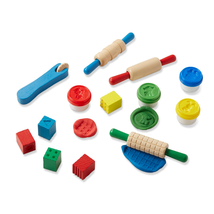 The loose pieces of the Melissa & Doug Shape, Model, and Mold Clay Activity Set - 4 Tubs of Modeling Dough and Tools