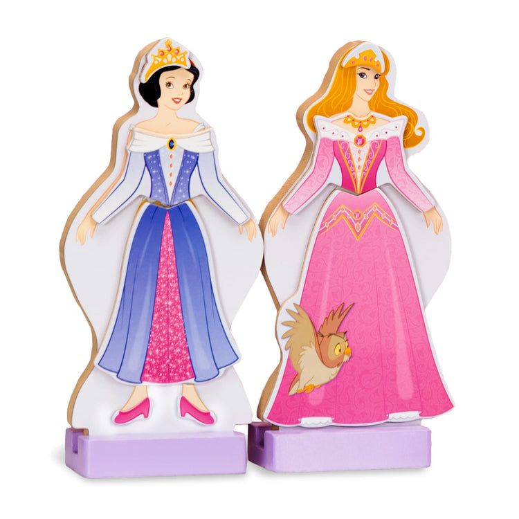 The loose pieces of the Melissa & Doug Disney Sleeping Beauty and Snow White Magnetic Dress-Up Wooden Doll Pretend Play Set (40+ pcs)