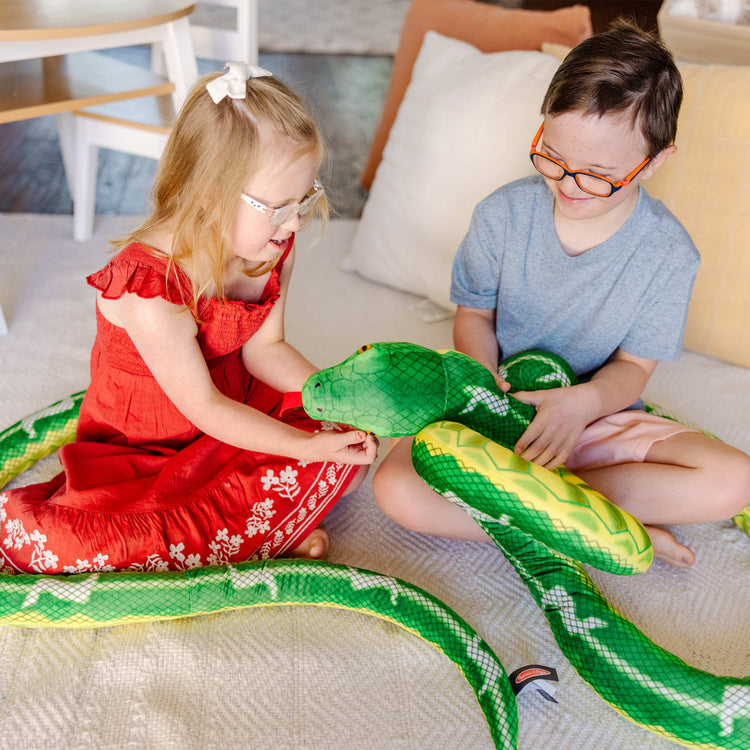 A kid playing with the Melissa & Doug Giant Boa Constrictor - Lifelike Stuffed Animal Snake (over 14 feet long)