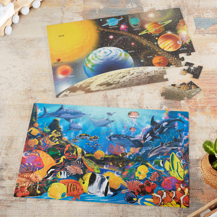 The front of the box for the Melissa & Doug Jumbo Jigsaw Floor Puzzle Set - Solar System and Underwater (2 x 3 feet each)