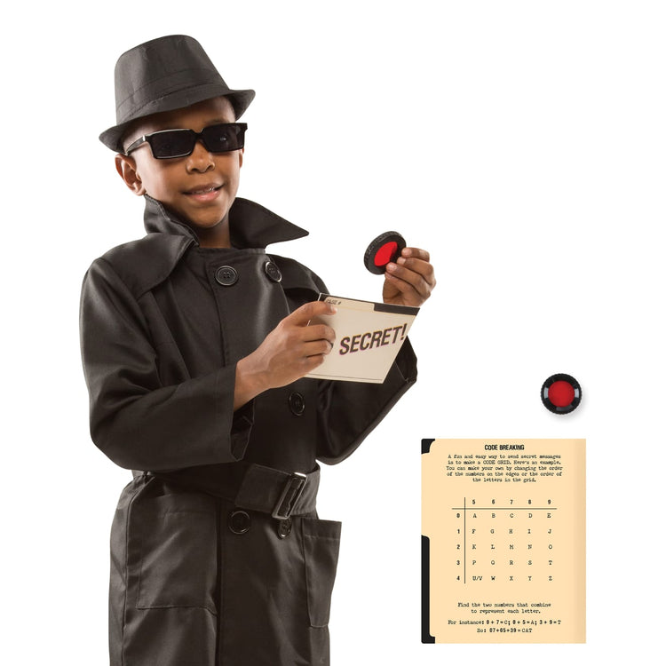 A child on white background with the Melissa & Doug Spy Costume Role Play Set