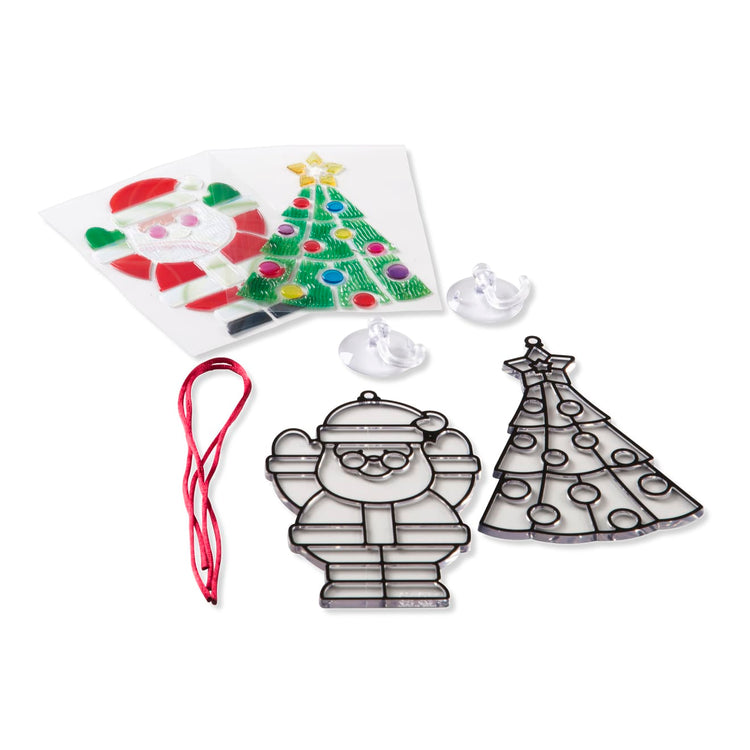 The loose pieces of the Melissa & Doug Stained Glass Made Easy Craft Kit - Santa and Tree Ornaments