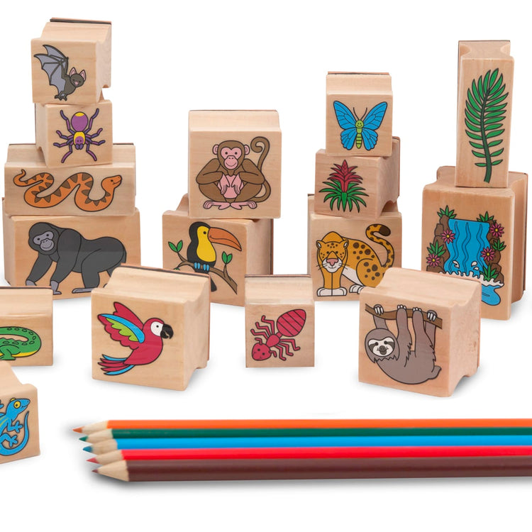 The loose pieces of the Melissa & Doug Stamp-a-Scene Stamp Set: Rain Forest - 20 Wooden Stamps, 5 Colored Pencils, and 2-Color Stamp Pad