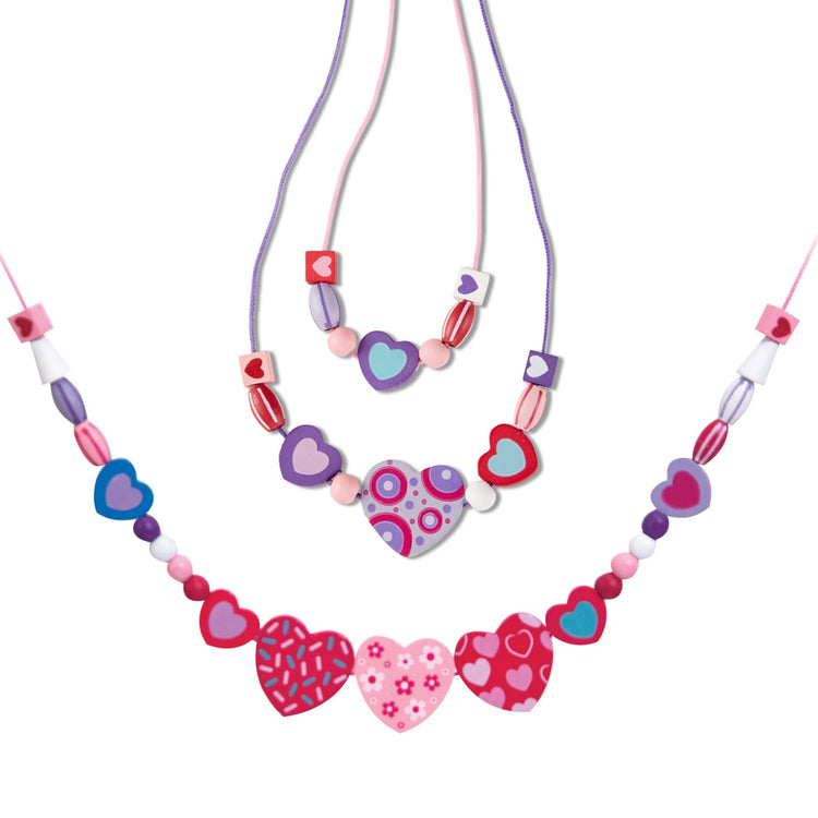 The loose pieces of the Melissa & Doug Created by Me! Heart Beads Wooden Bead Kit, 120+ Beads and 5 Cords for Jewelry-Making