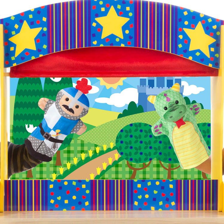 A child on white background with the Melissa & Doug Tabletop Puppet Theater - Sturdy Wooden Construction