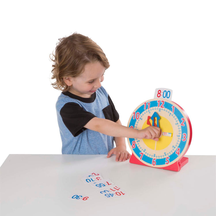 A child on white background with the Melissa & Doug Turn & Tell Wooden Clock - Educational Toy With 12+ Reversible Time Cards