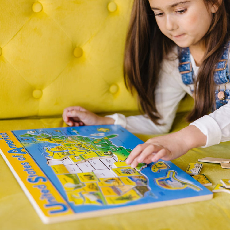 A kid playing with the Melissa & Doug USA Map Wooden Puzzle (45 pcs)