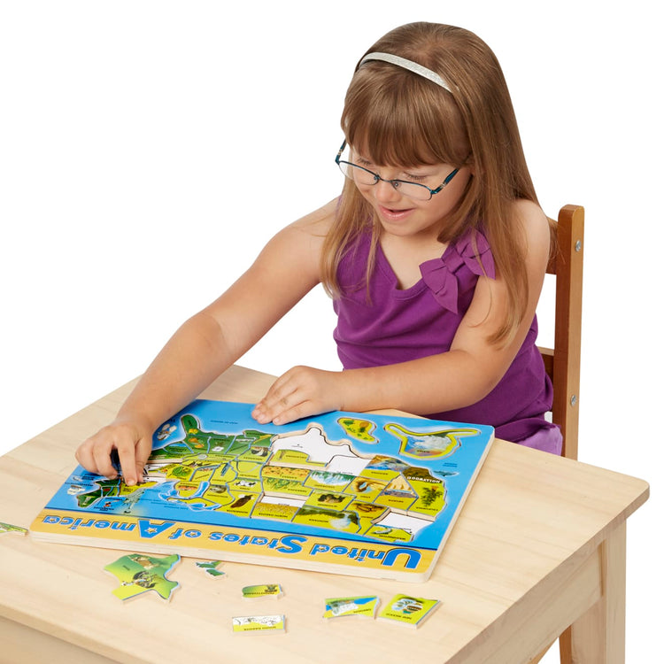 A child on white background with the Melissa & Doug USA Map Wooden Puzzle (45 pcs)