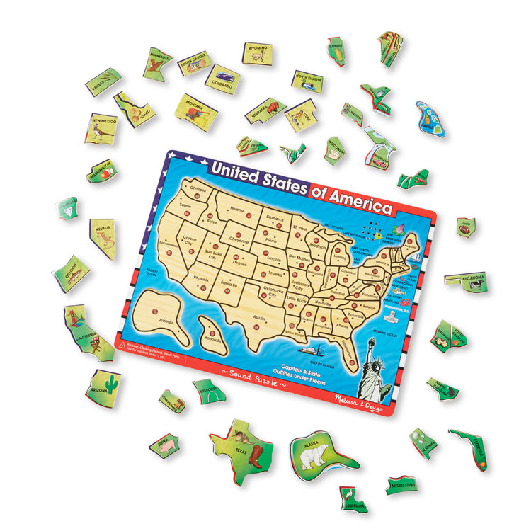 The loose pieces of the Melissa & Doug USA Map Sound Puzzle - Wooden Puzzle With Sound Effects (40 pcs)