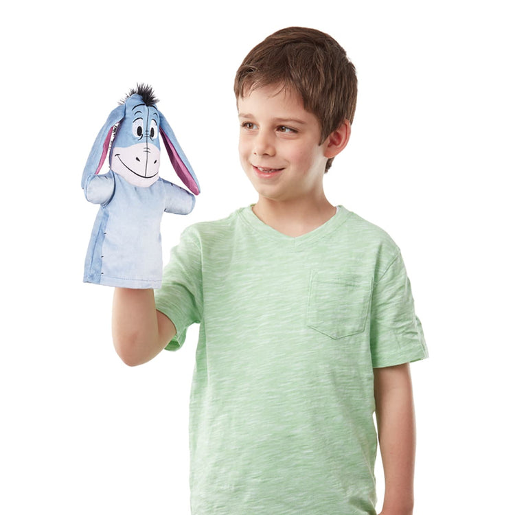 A child on white background with the Winnie the Pooh Soft & Cuddly Hand Puppets
