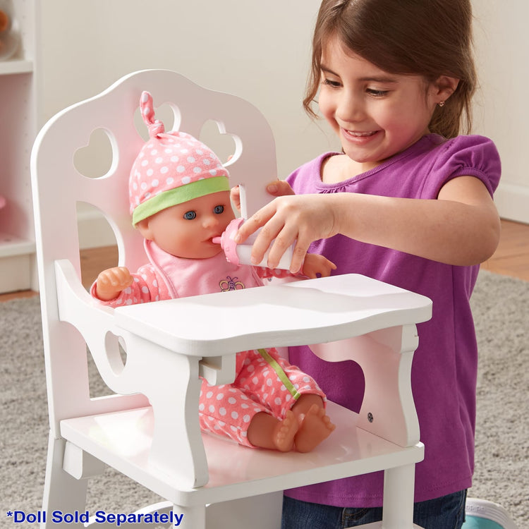 A kid playing with the Melissa & Doug Mine to Love Wooden Play High Chair for Dolls, Stuffed Animals - White (18”H x 8”W x 11”D Assembled)