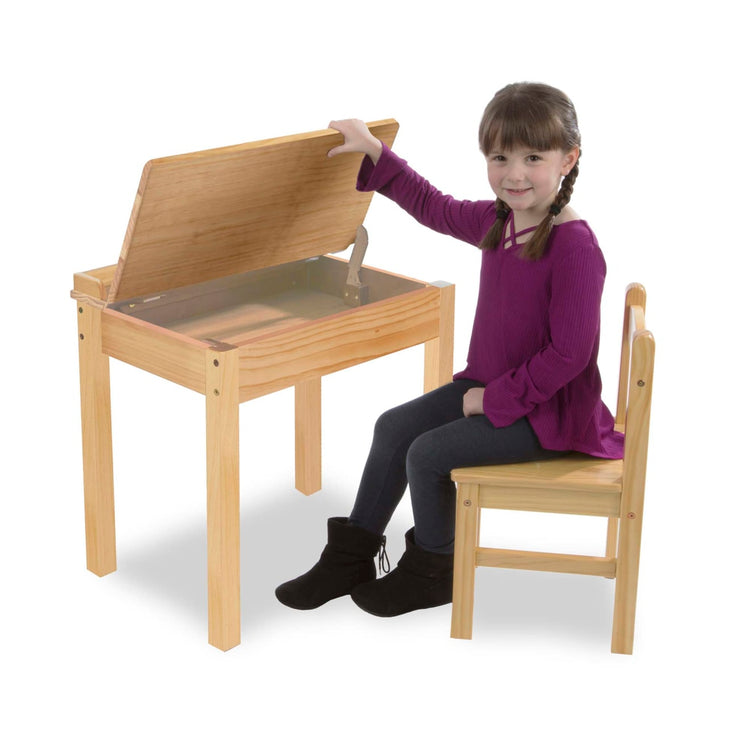 A child on white background with the Melissa & Doug Wooden Child's Lift-Top Desk & Chair - Honey