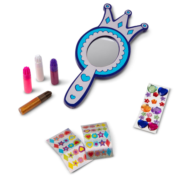 The loose pieces of the Melissa & Doug Decorate-Your-Own Wooden Princess Mirror Craft Kit