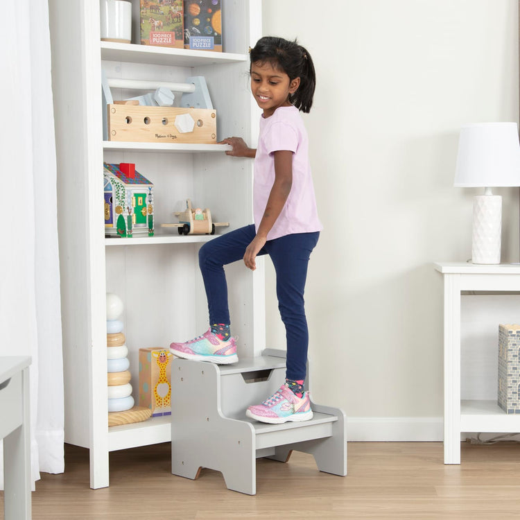 A kid playing with the Melissa & Doug Kids Furniture Wooden Step Stool - Gray