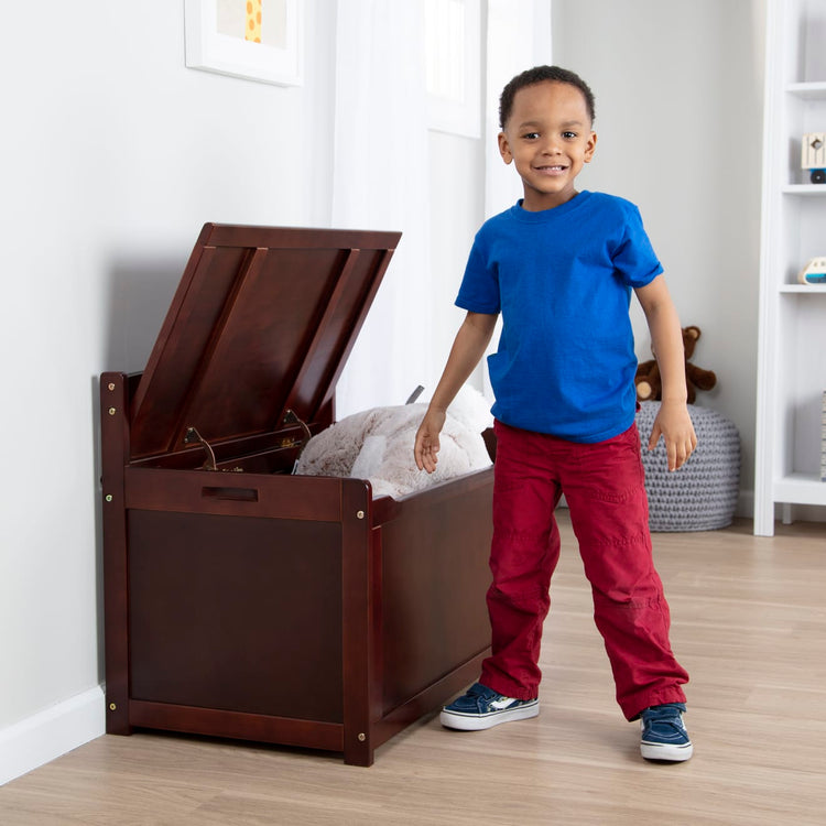 A kid playing with the Melissa & Doug Wooden Toy Chest (Espresso)