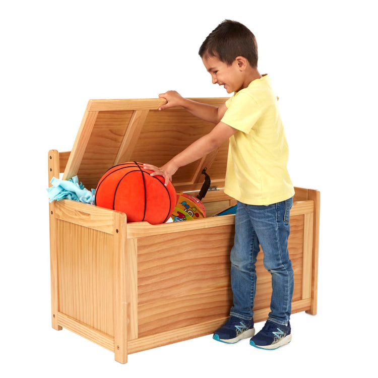 A child on white background with the Melissa & Doug Wooden Toy Chest (Honey)