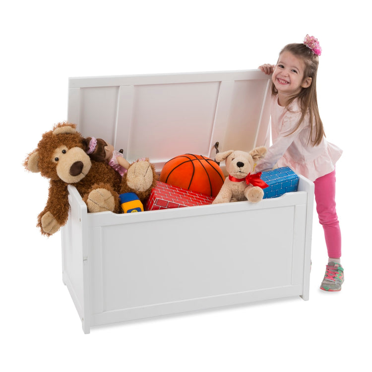 A child on white background with the Melissa & Doug Wooden Toy Chest (White)