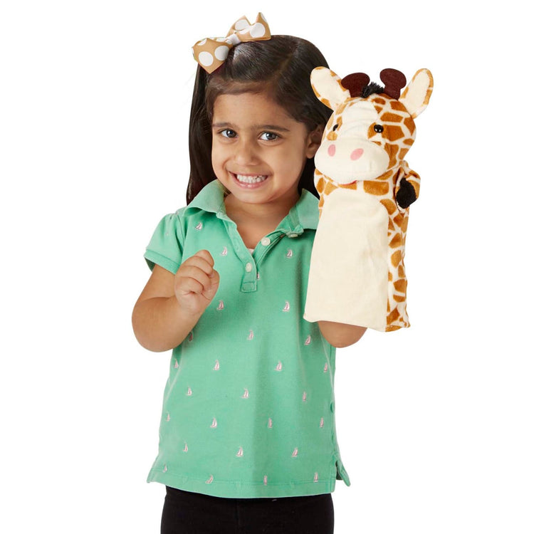 A child on white background with the Melissa & Doug Zoo Friends Hand Puppets (Set of 4) - Elephant, Giraffe, Tiger, and Monkey